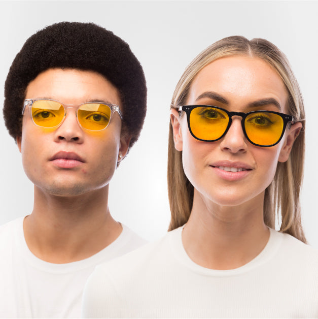 male and female wearing a pair of yellow lens, light sensitivity glasses